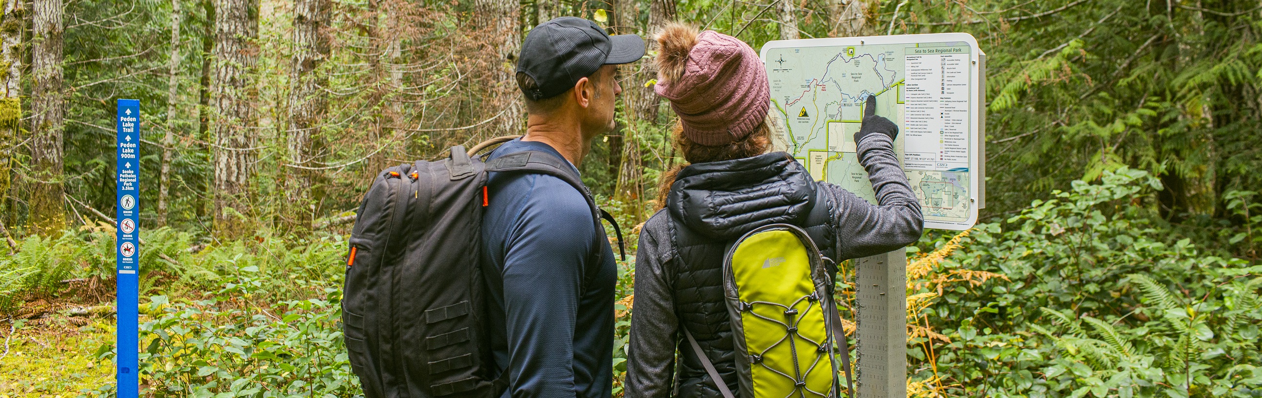 Hikers at a trail map
